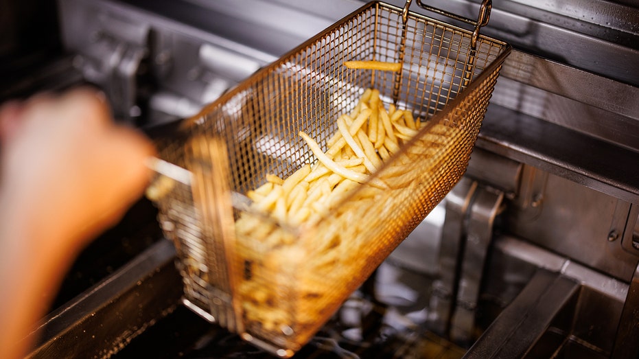 A basket of McDonald's fries getting cooked in oil