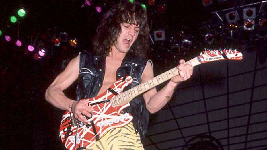 eddie van halen performing in 1984 with guitar