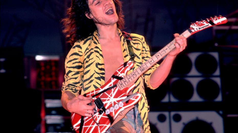 eddie van halen with guitar in 1984 on stage smiling