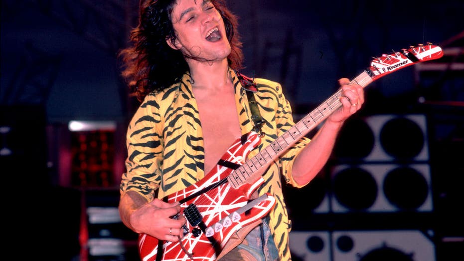 eddie van halen with guitar in 1984 on stage smiling