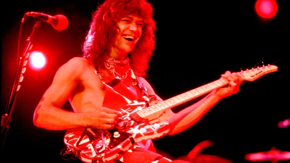 eddie van halen playing with guitar in 1983