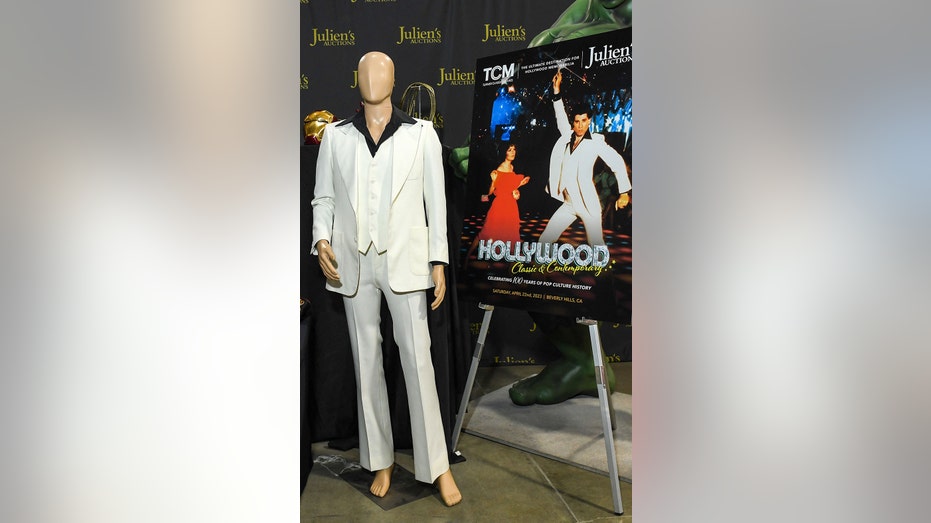 A mannequin wearing a three-piece white suit