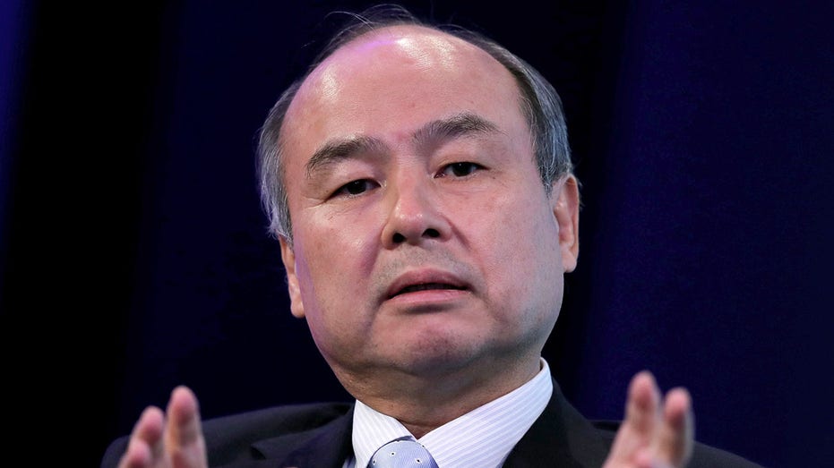 Masayoshi Son speaking while gesturing with his hands