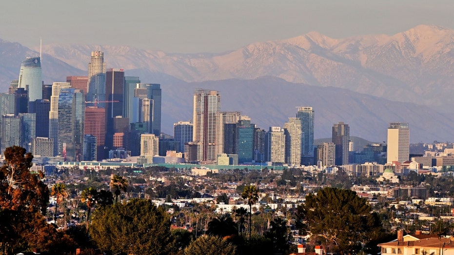Snow-capped mountains behind the Los Angeles skyline