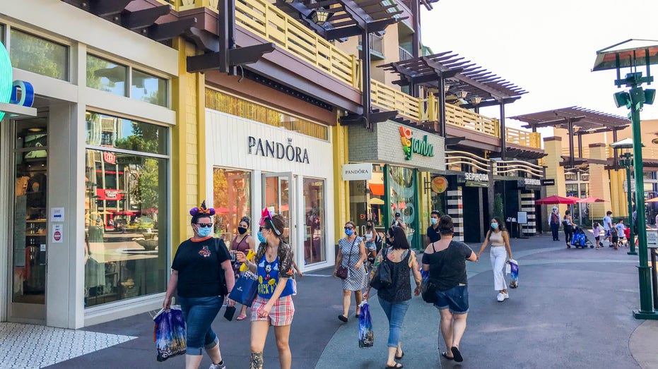People walk through the Downtown Disney District