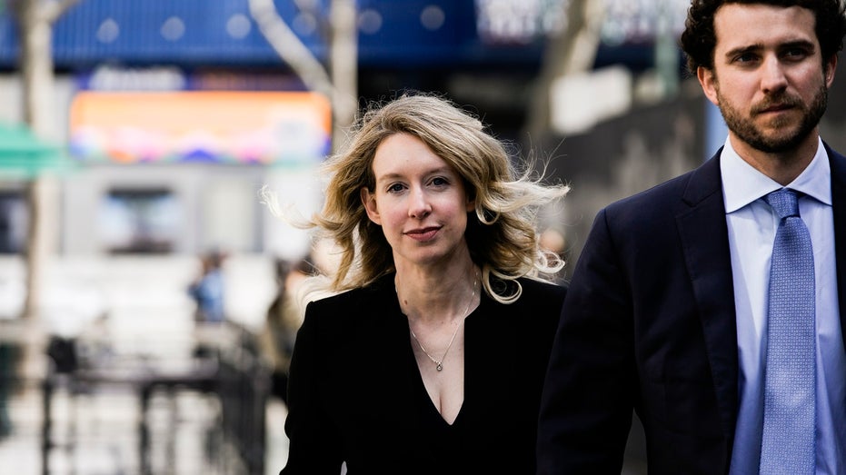 Elizabeth Holmes and partner Billy Evans outside court