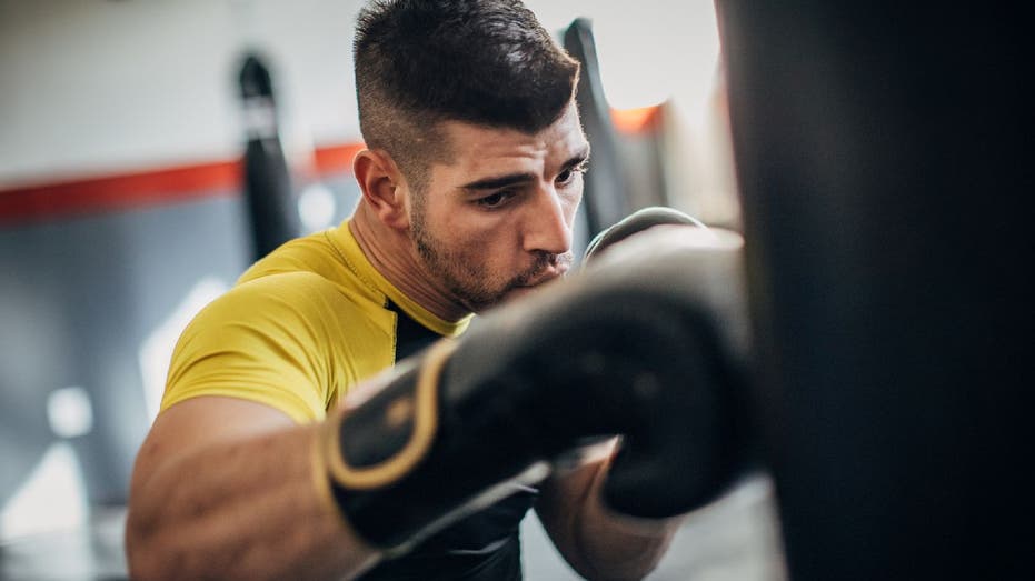 Man hitting punching bag