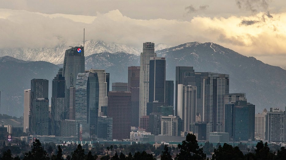 downtown LA skyline, mountains background