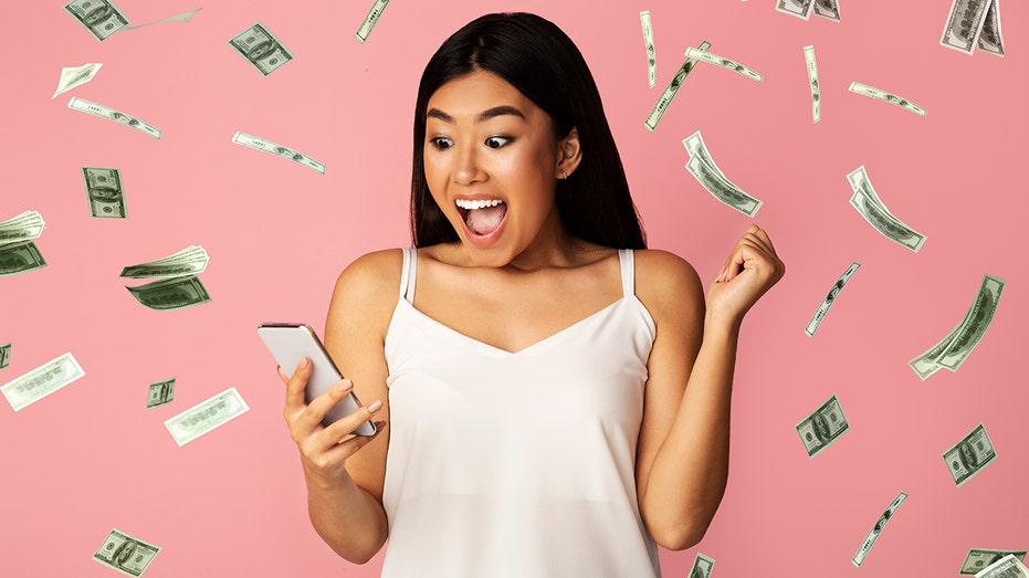 Excited woman surrounded by money