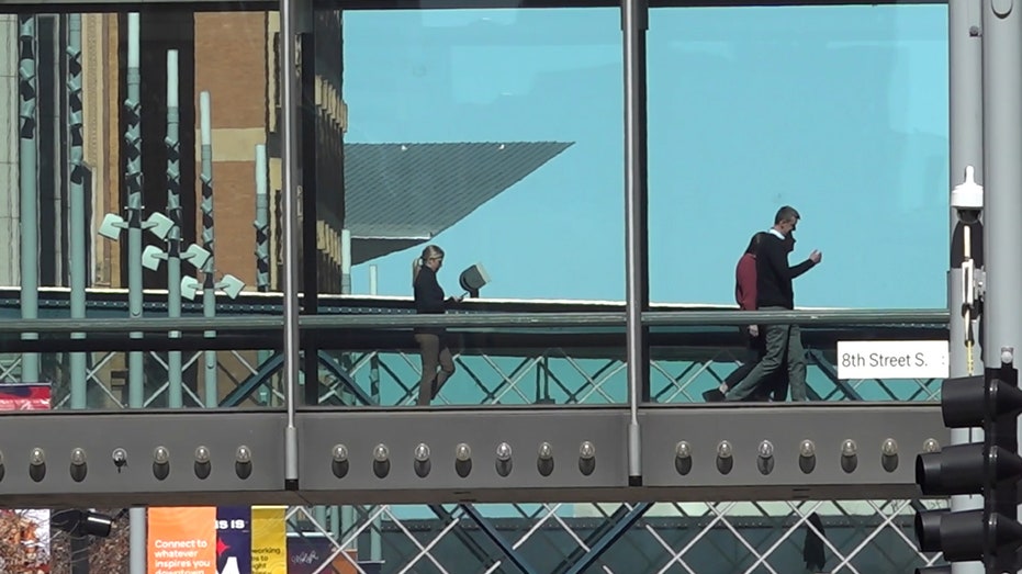 People walk through a Minneapolis skywalk
