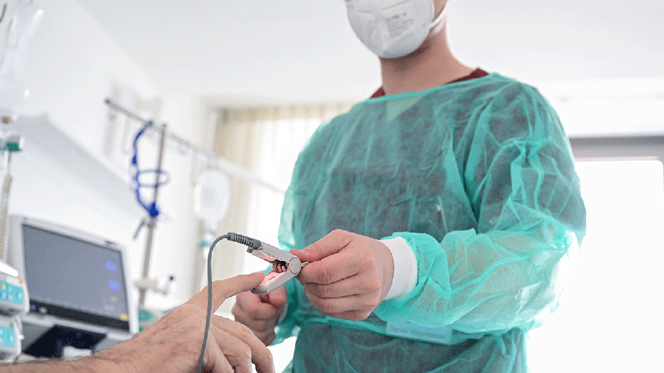 Nurse in a hospital room with patient
