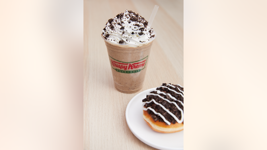 Krispy Kreme's Oreo Frozen Mocha Latte next to its Oreo Cookies & Kreme Filled Doughnut.