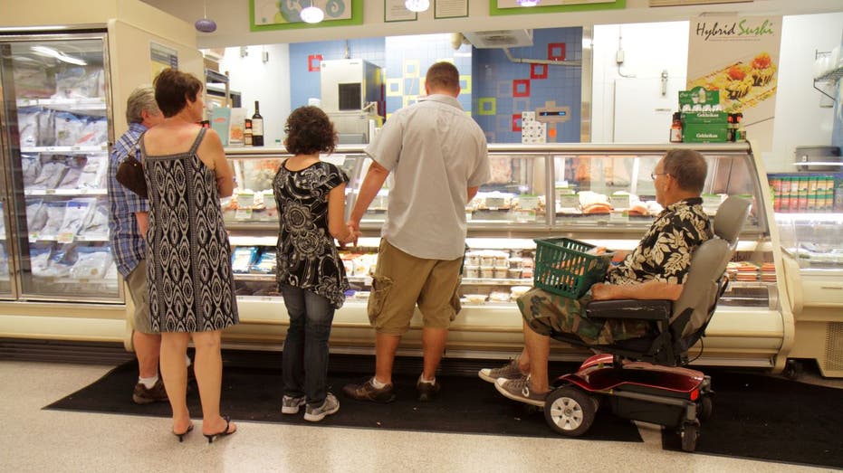 Customers standing near seafood counter