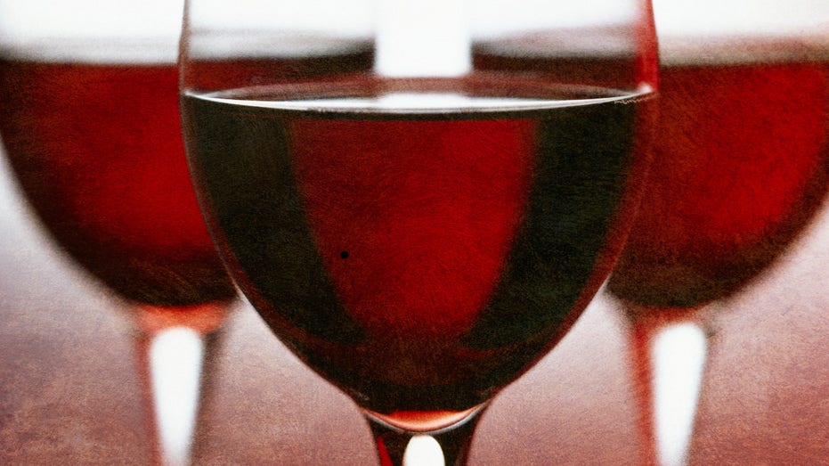 Three stemmed glasses of rich red wine