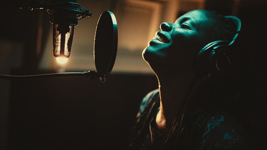 woman sings into microphone