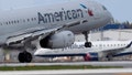 An American Airlines plane lands on a runway near a parked JetBlue plane. (Photo by Joe Raedle/Getty Images) - Fox News