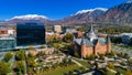 Downtown Provo, Utah aerial, with the Provo City Center Temple on the right (also the former Provo Tabernacle) and One Nu Skin Plaza on the left, with the snow capped Wasatch Mountain Range in the background.