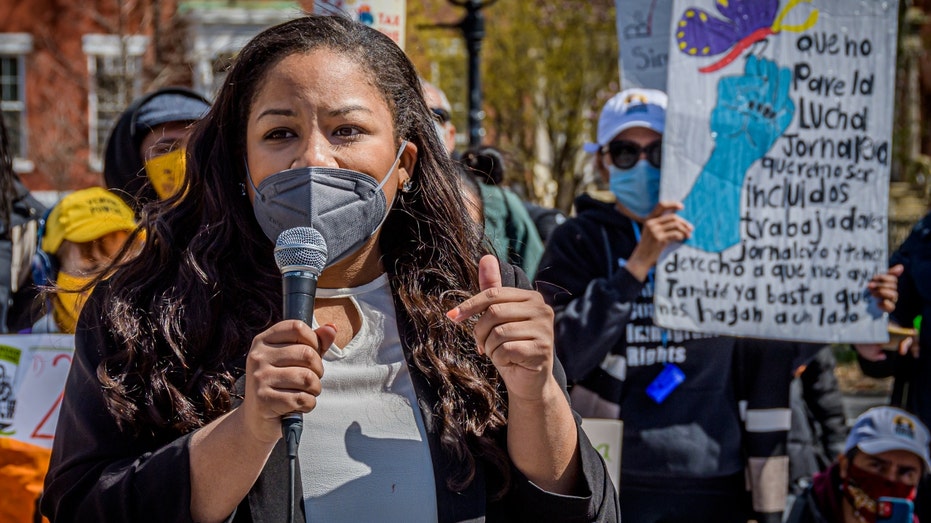 A masked Amanda Septimo seen speaking