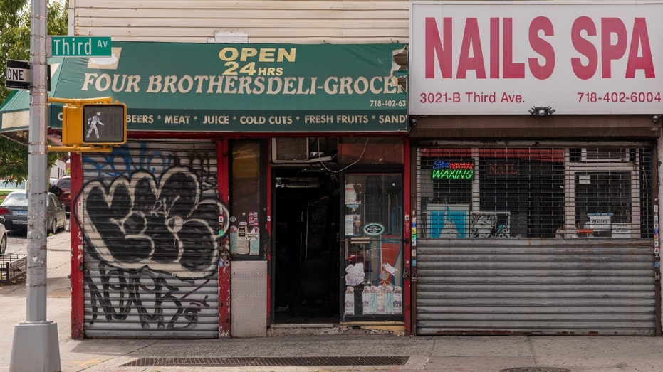 A bodega is seen next to a closed nail salon in the Bronx