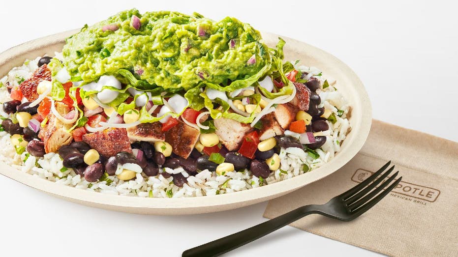 Chipotle burrito bowl with rice, chicken, cheese and guacamole.