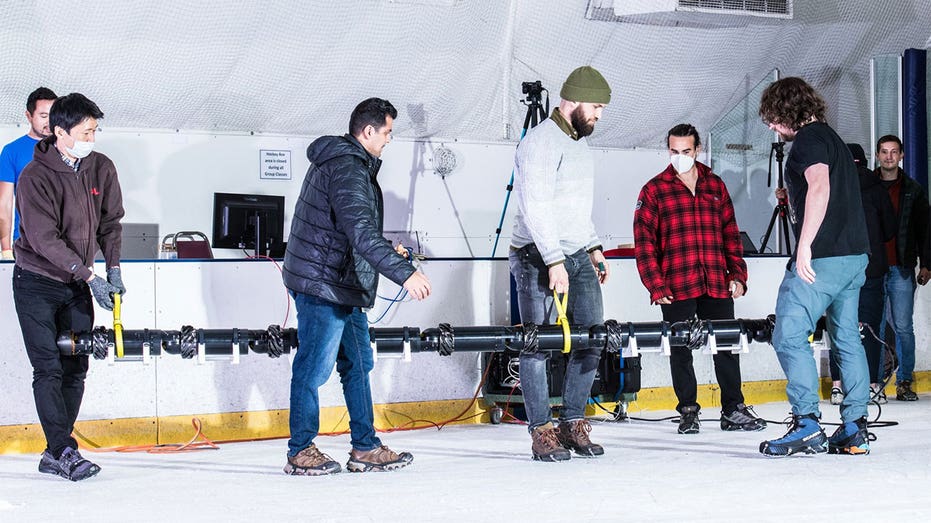 EELS Team Members move 9-link robot