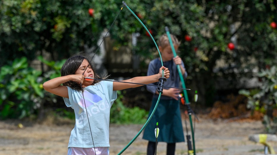 children practice archery