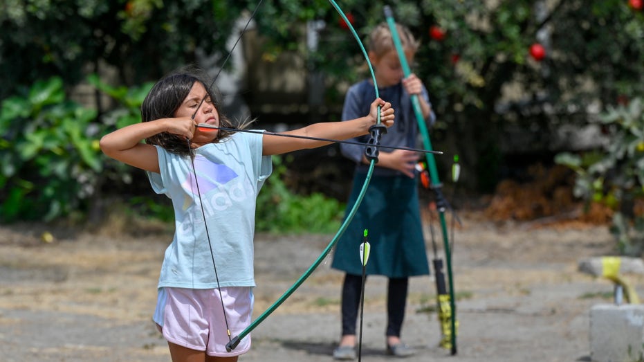 children practice archery