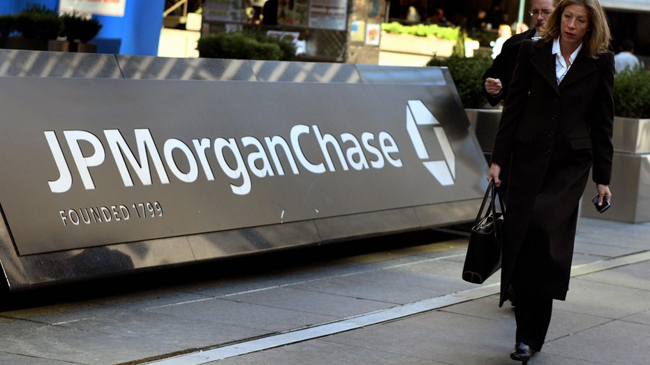 pedestrians walk by the JPMorgan Chase headquarters 