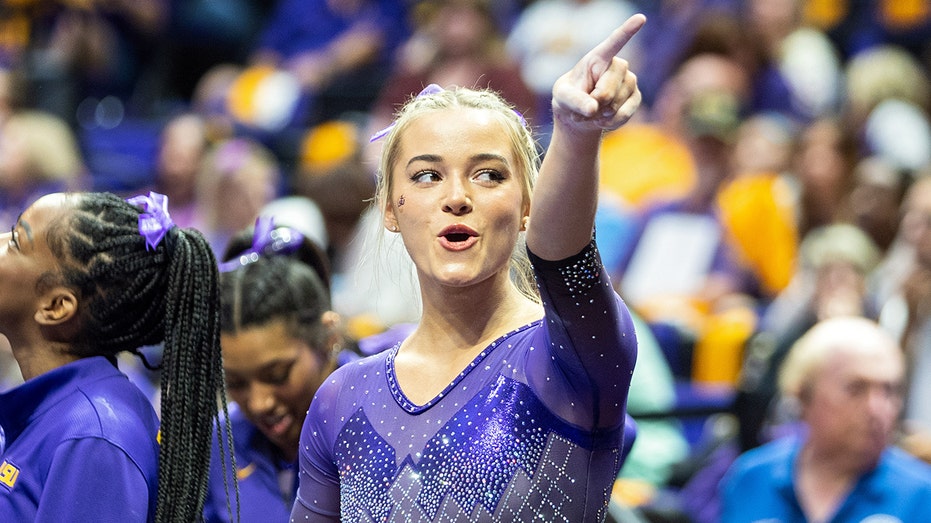 Olivia Dunne points to the crowd