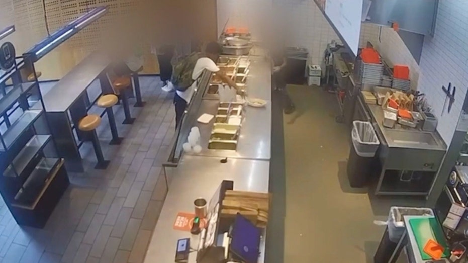 Customer reaches across Chipotle counter