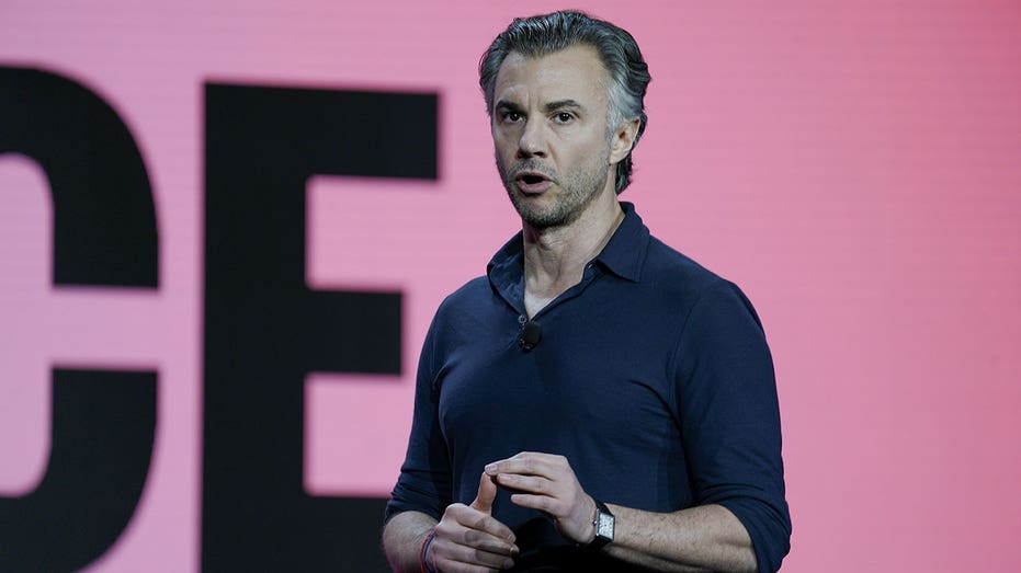 Diego Scotti wears black shirt with pink background