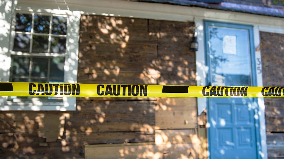 house encased in yellow tape