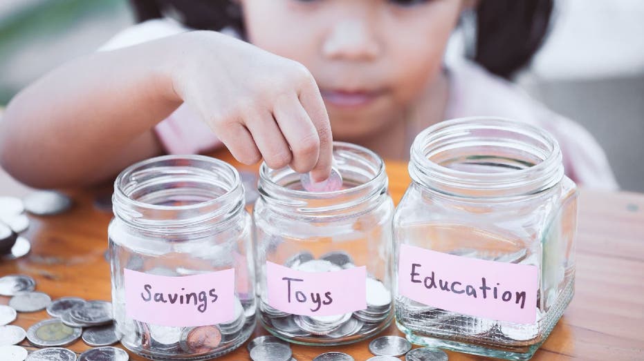 Child counts coins successful solid jars branded savings, toys and education.