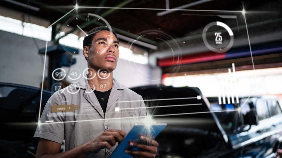 young repair shop worker using futuristic interface