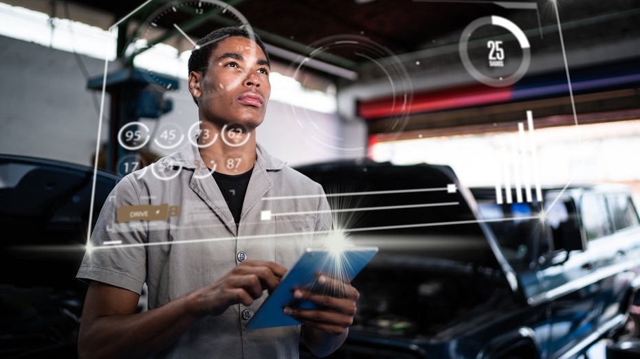 young repair shop worker using futuristic interface