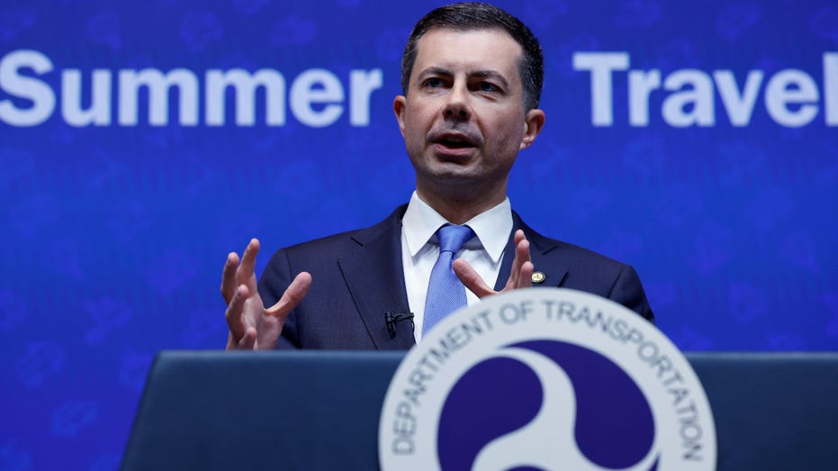 U.S. Transportation Secretary Pete Buttigieg speaks at a podium about summer air travel