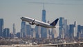 A United Airlines aircraft takes off in front of New York Citys skyline at Newark Liberty International Airport in Newark, New Jersey, on March 9, 2023. - Airlines and unions disagree on many aspects relating to todays tight labor market, but concur on at least one thing: the need to diversify the pilot workforce pool. 