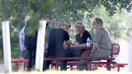 Elizabeth Holmes is seen sitting at a table Tuesday, June 6 with her husband Billy Evans and parents Christian and Noel at Federal Prison Camp Bryan, near her hometown of Houston. 