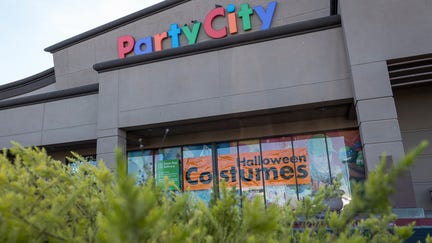 A "Halloween Costumes" sign is displayed in the window of a Party City store in Richmond, California, U.S., on Wednesday, Sept. 22, 2020. Halloween is a key holiday for Party City, but with Americans wearing different kinds of masks and keeping their distance, its scary season could extend well beyond the end of the October. Photographer: David Paul Morris/Bloomberg via Getty Images