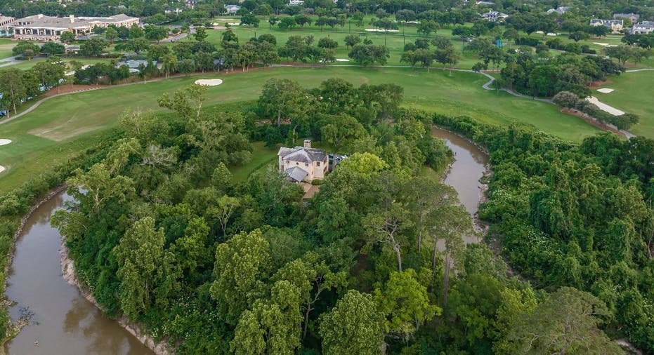 Aerial view of The Lodge in Hunters Creek with Buffalo Bayou and landscape.