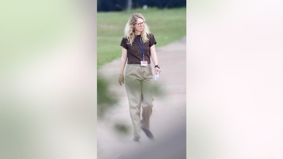 Elizabeth Holmes walking in prison