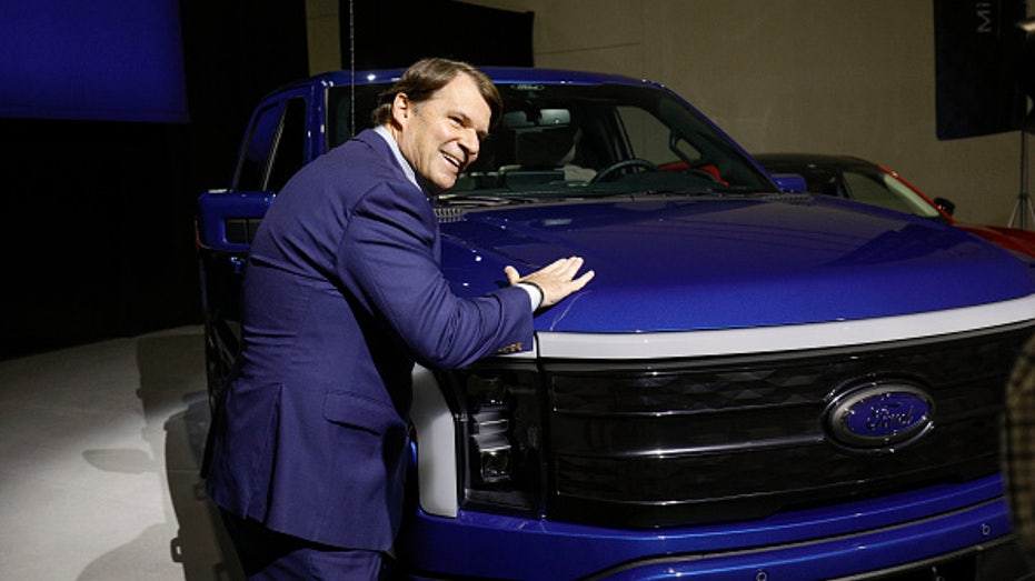 Ford CEO Jim Farley and Ford F-150 Lightning truck