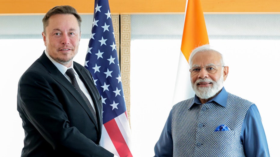 Tesla CEO Elon Musk and Indian Prime Minister Narendra Modi shake hands