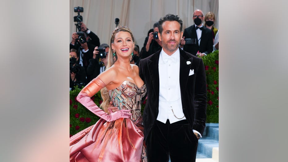 Blake Lively in copper gown with Ryan Reynolds in a tuxedo