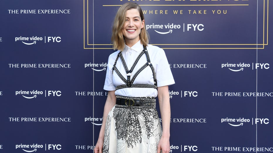 Rosamund Pike in a black and white patterned dress