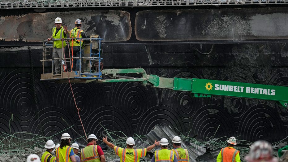 Construction crews work to rebuild the collapsed portion of Interstate 95 near Philadelphia