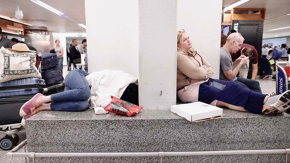 People waiting for their flight reschedule inside of the Newark International Airport