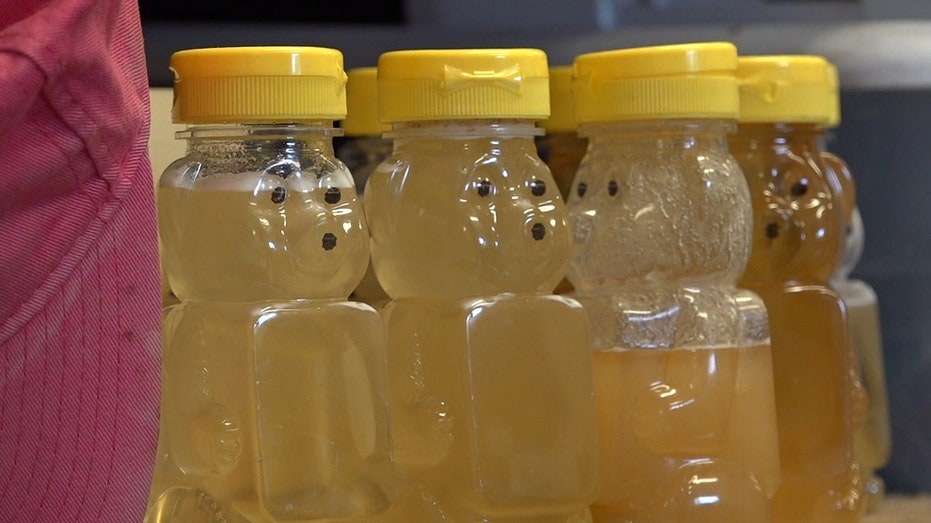 bottles of raw honey sitting on a shelf
