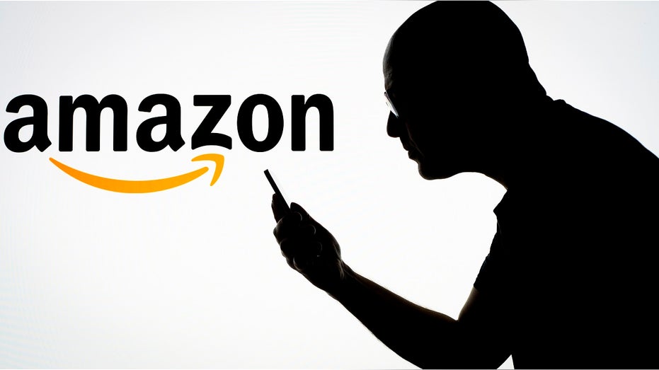Amazon logo, man holding cell phone
