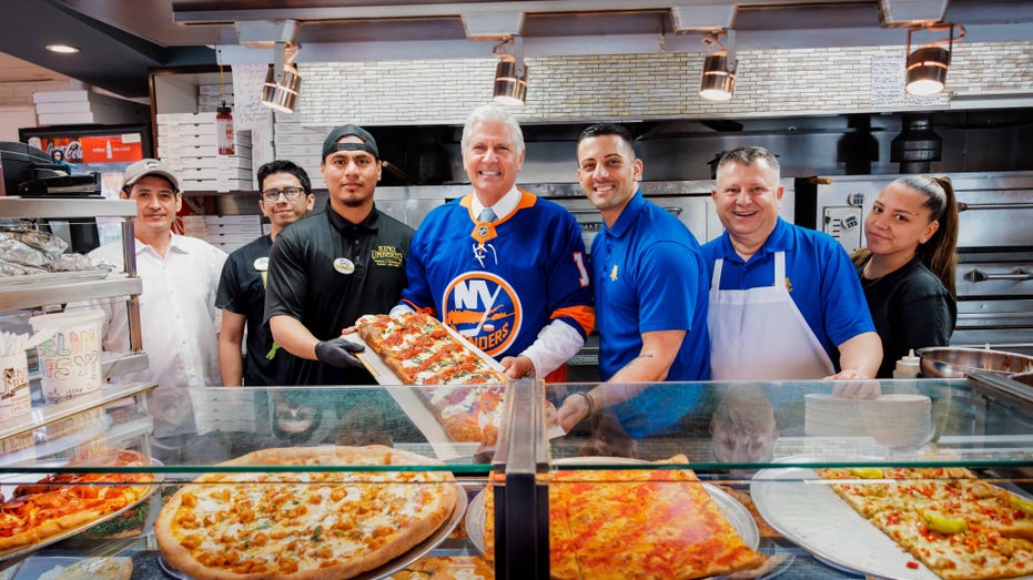 Bruce Blakeman smiles at local pizzeria with staff
